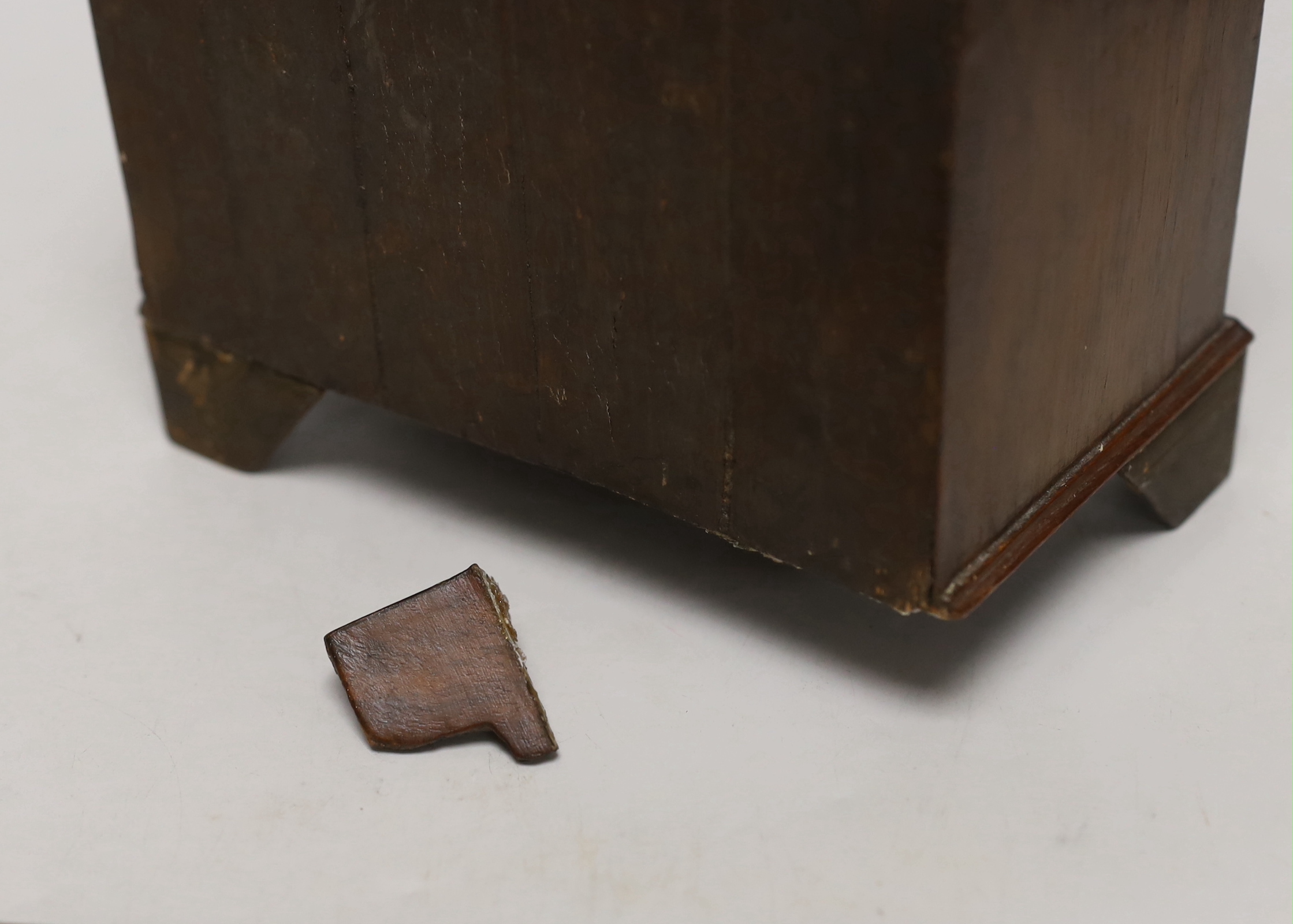 A miniature walnut chest of drawers and a bookslide, relating to the fire at York Minster, 34cm wide (closed)